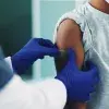 How can public health professionals overcome vaccine hesitation?