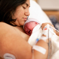 mother-holding-brand-new-baby-in-hospital-delivery-room